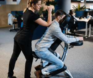 woman giving chair massage to a seated man