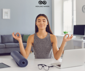 A woman meditating at her desk